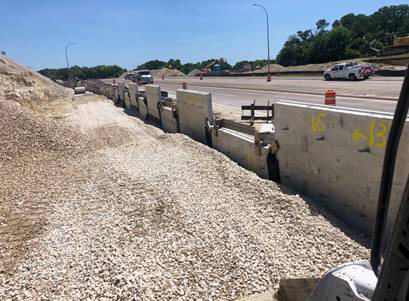 Soil nail wall construction against a road in Aurora.