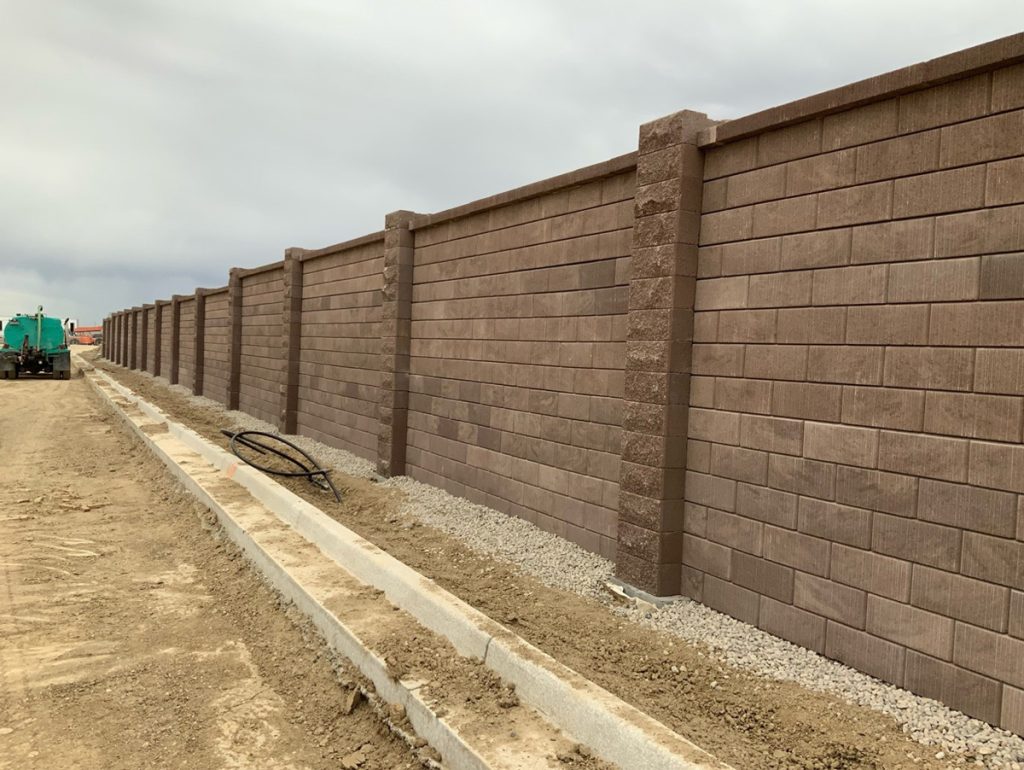 A brown, brick sound barrier wall in Aurora.