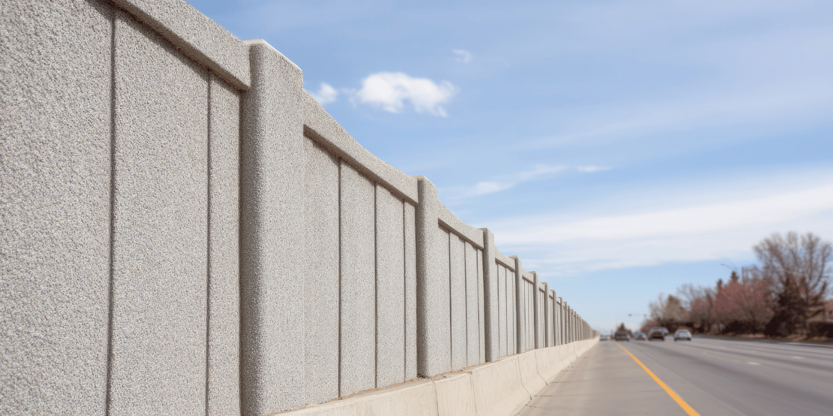 A sound barrier wall on a busy road